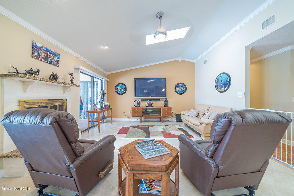 1401 Meadowbrook Road Northeast Palm Bay, FL 32905 - Photo 13 of 46 a living room with furniture and a table