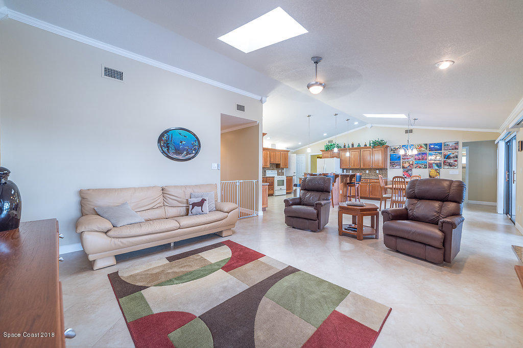 1401 Meadowbrook Road Northeast Palm Bay, FL 32905 - Photo 14 of 46 a living room with furniture kitchen view and a table