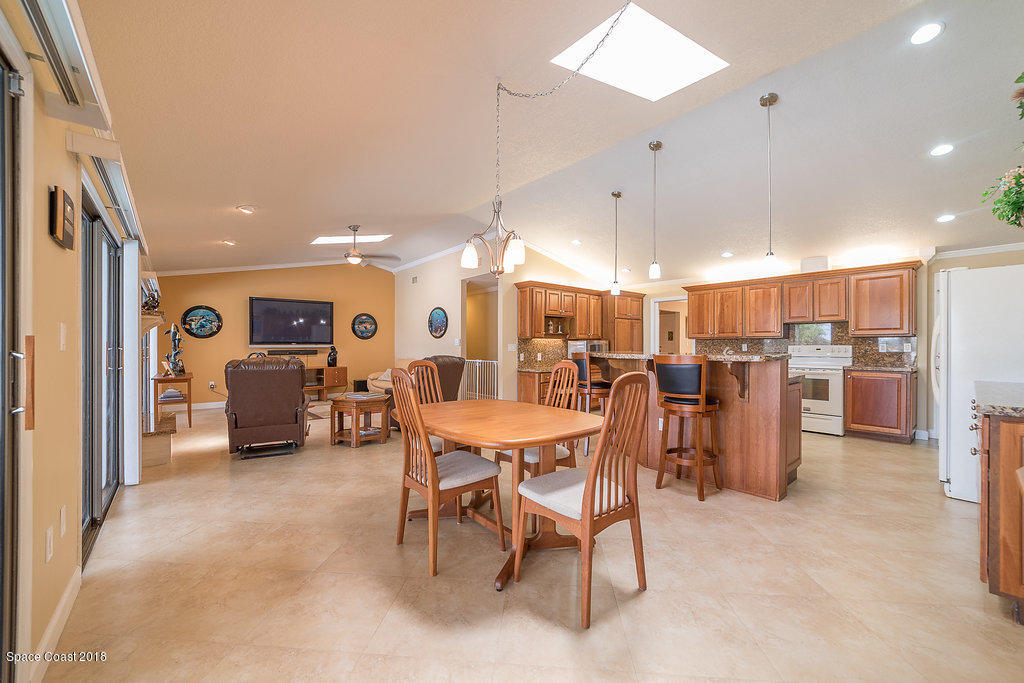 1401 Meadowbrook Road Northeast Palm Bay, FL 32905 - Photo 15 of 46 a view of a dining room with furniture