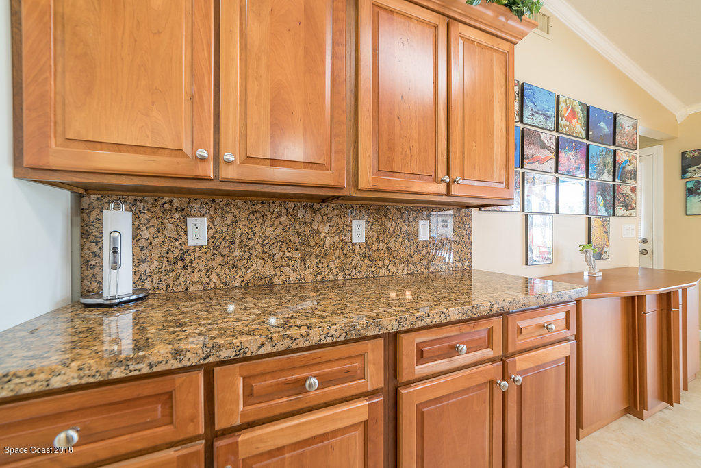 1401 Meadowbrook Road Northeast Palm Bay, FL 32905 - Photo 16 of 46 a kitchen with granite countertop cabinets and window
