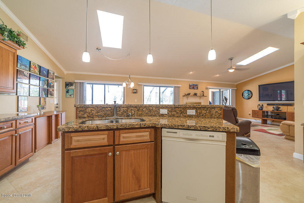 1401 Meadowbrook Road Northeast Palm Bay, FL 32905 - Photo 18 of 46 a kitchen with stainless steel appliances granite countertop a stove and cabinets
