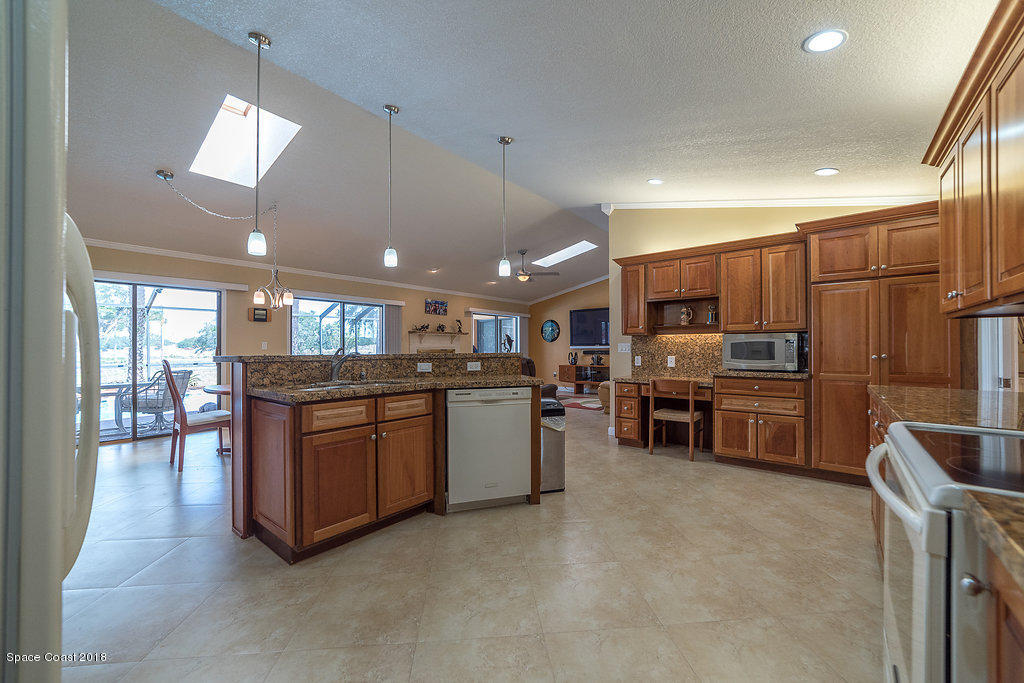 1401 Meadowbrook Road Northeast Palm Bay, FL 32905 - Photo 22 of 46 a kitchen with sink cabinets and stainless steel appliances