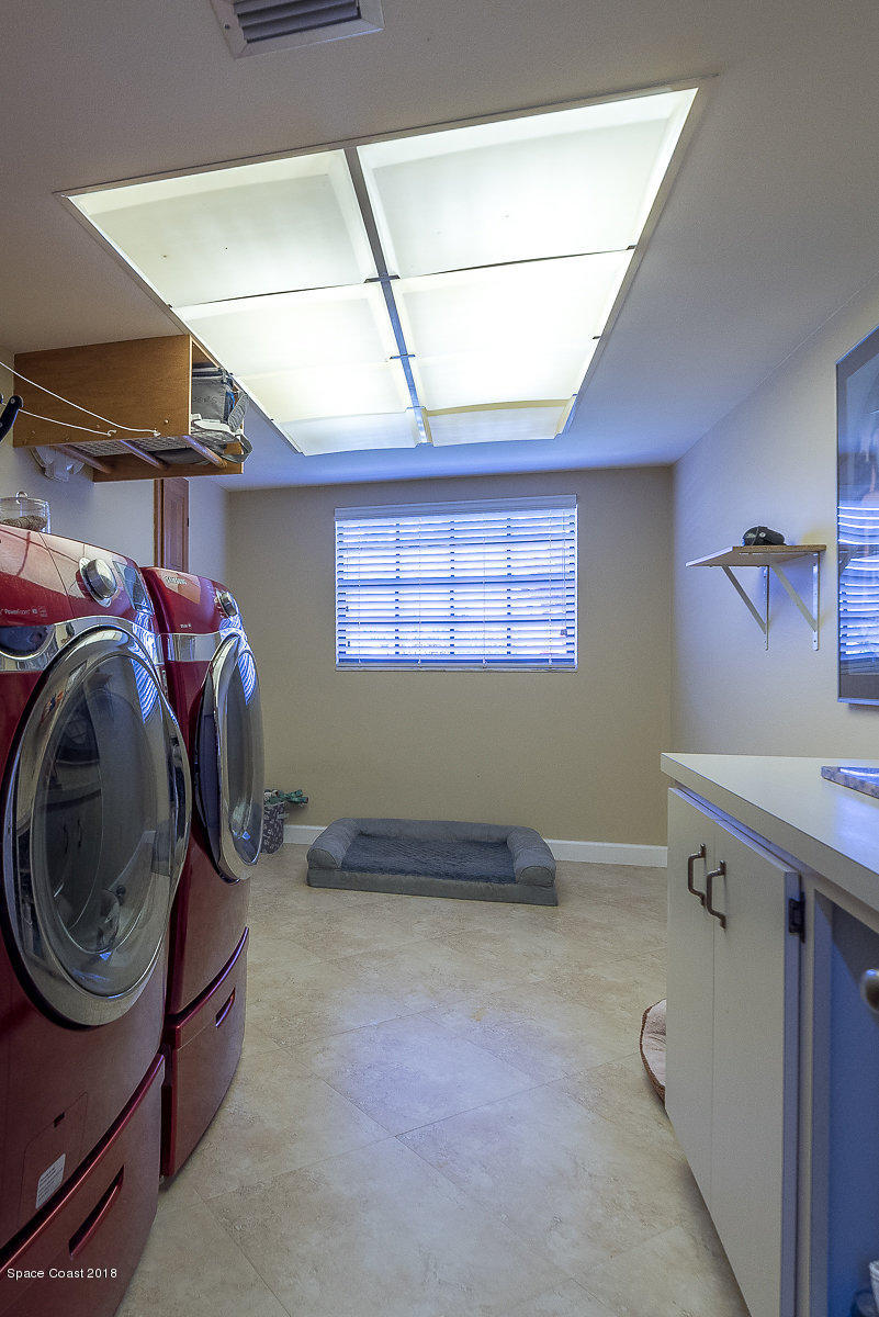 1401 Meadowbrook Road Northeast Palm Bay, FL 32905 - Photo 24 of 46 a utility room with dryer and washer