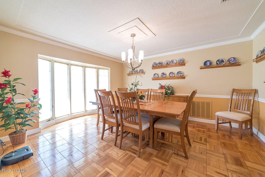 1401 Meadowbrook Road Northeast Palm Bay, FL 32905 - Photo 26 of 46 a view of a dining room with furniture window and wooden floor