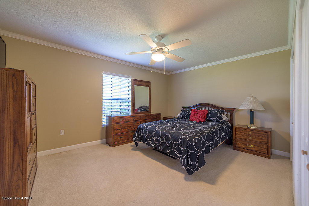 1401 Meadowbrook Road Northeast Palm Bay, FL 32905 - Photo 29 of 46 a living room with a bed furniture and a window