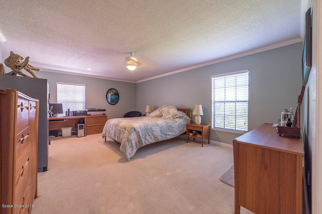 1401 Meadowbrook Road Northeast Palm Bay, FL 32905 - Photo 32 of 46 a bedroom with a bed and a window