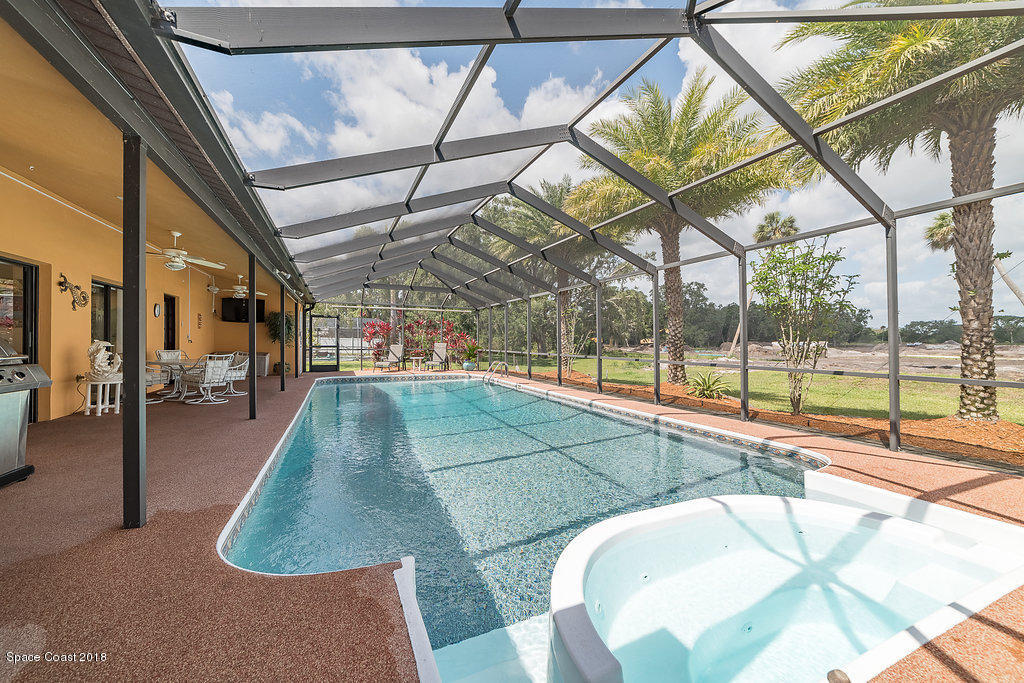 1401 Meadowbrook Road Northeast Palm Bay, FL 32905 - Photo 7 of 46 a view of a swimming pool with a yard