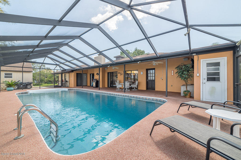 1401 Meadowbrook Road Northeast Palm Bay, FL 32905 - Photo 8 of 46 a view of a swimming pool with a patio