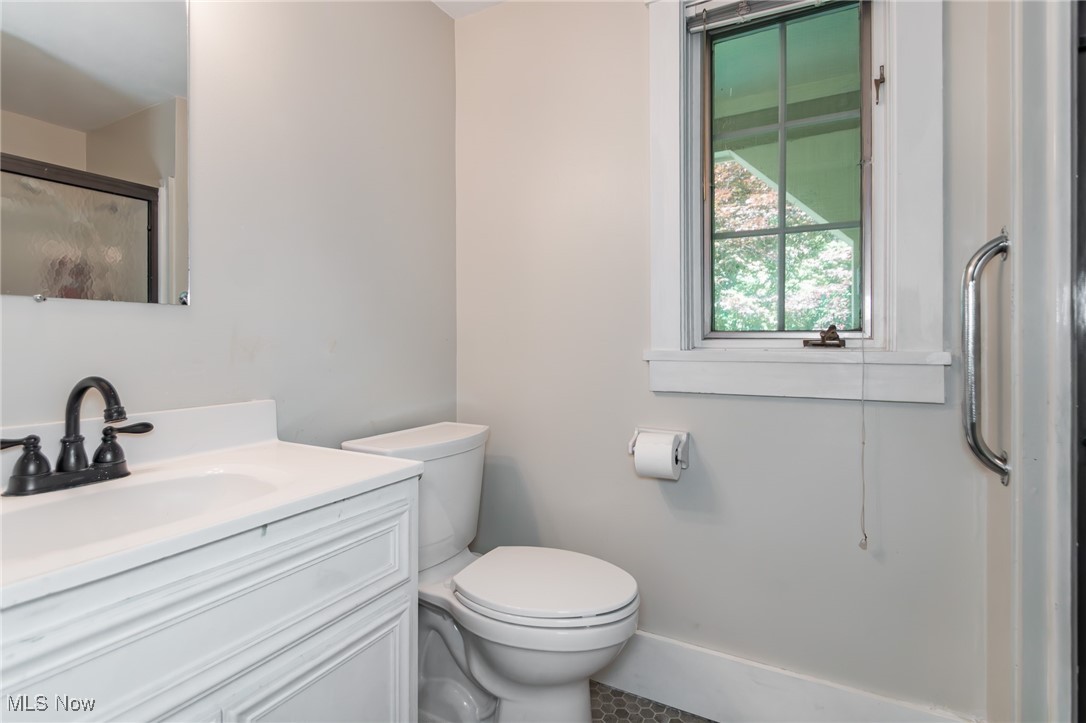 7806 Fairidge Road Willoughby, OH 44094 - Photo 21 of 41 Bathroom with vanity and a shower with door