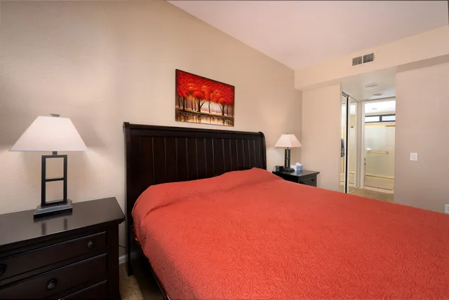 a bed room with a bed and a night stand