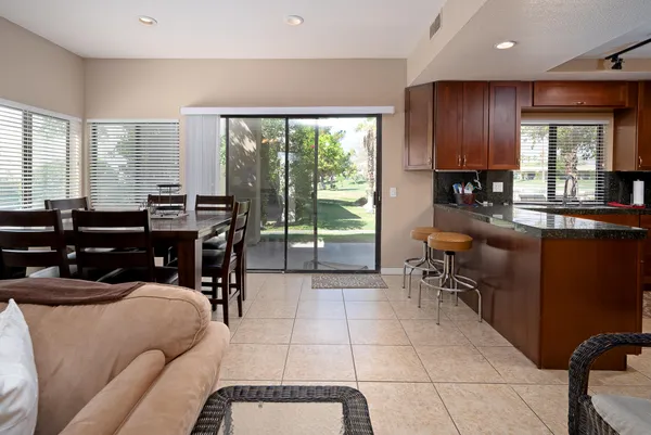 a living room filled with furniture and a large window