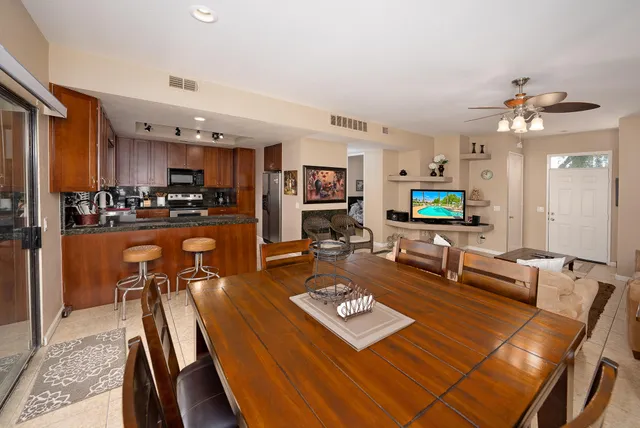 a living room with lots of furniture and kitchen view