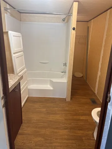 a bathroom with a tub and shower