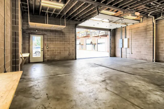 a view of a hall with wooden floor and a window