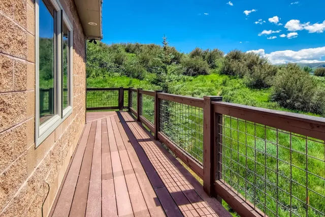 a view of balcony with wooden floor