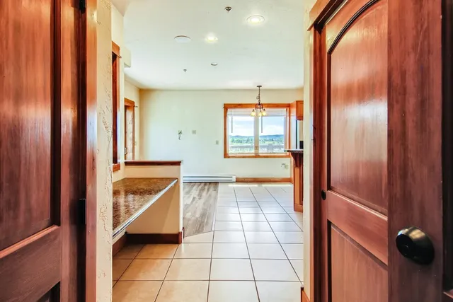 a view of an empty room with a sink and a mirror