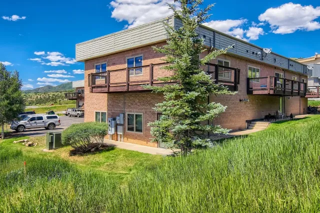 a view of a house with a yard and a garden