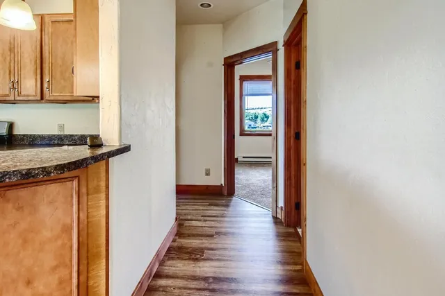 a view of a hallway with wooden floor