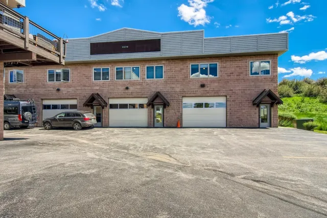 a building with a lot of parking and garage