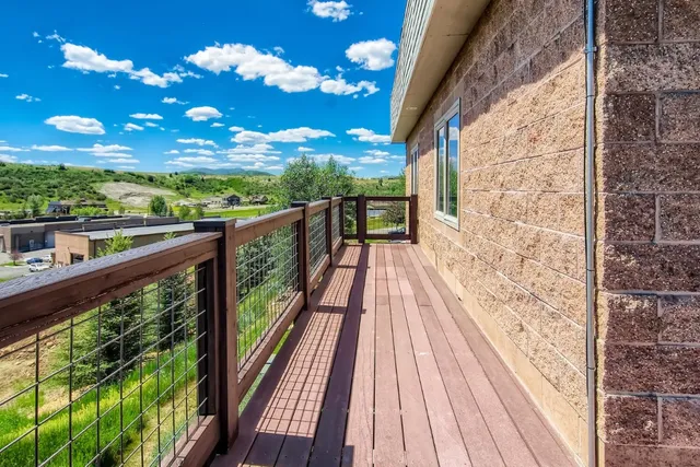 a view of a balcony with wooden floor