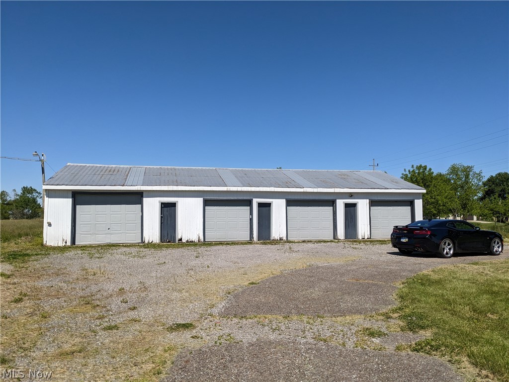 13096 Smith Road Wellington, OH 44090 - Photo 5 of 24 Multi-bay structure featuring a metal roof and white siding
