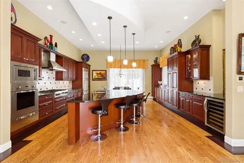 a large kitchen with a table and chairs