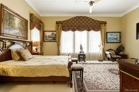 a bedroom with a bed mirror and window