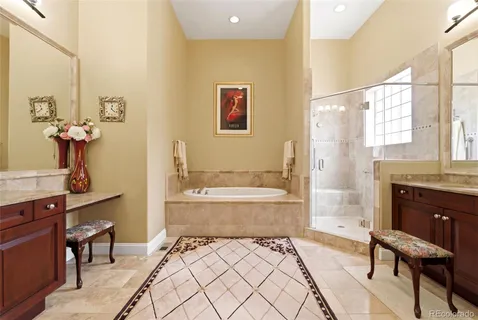a spacious bedroom with a bed and a chandelier