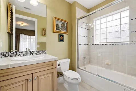 a bathroom with a sink mirror toilet and bathtub