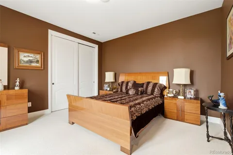 a bedroom with a bed and a dresser in it