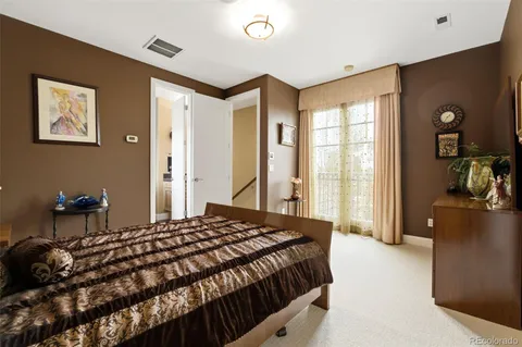 a bedroom with a bed and a dresser with mirror