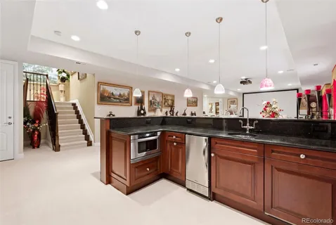 a kitchen with stainless steel appliances granite countertop a stove and a sink