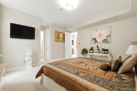 a bedroom with a large bed and a flat screen tv