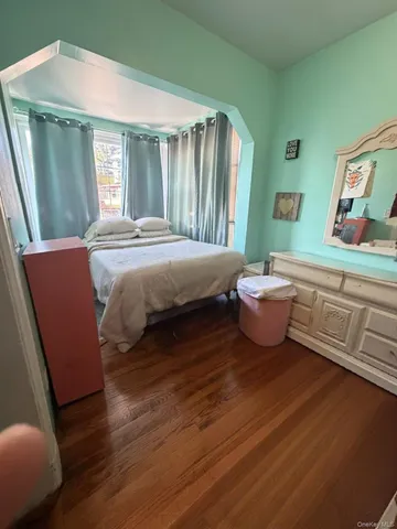 a spacious bedroom with a bed and a window