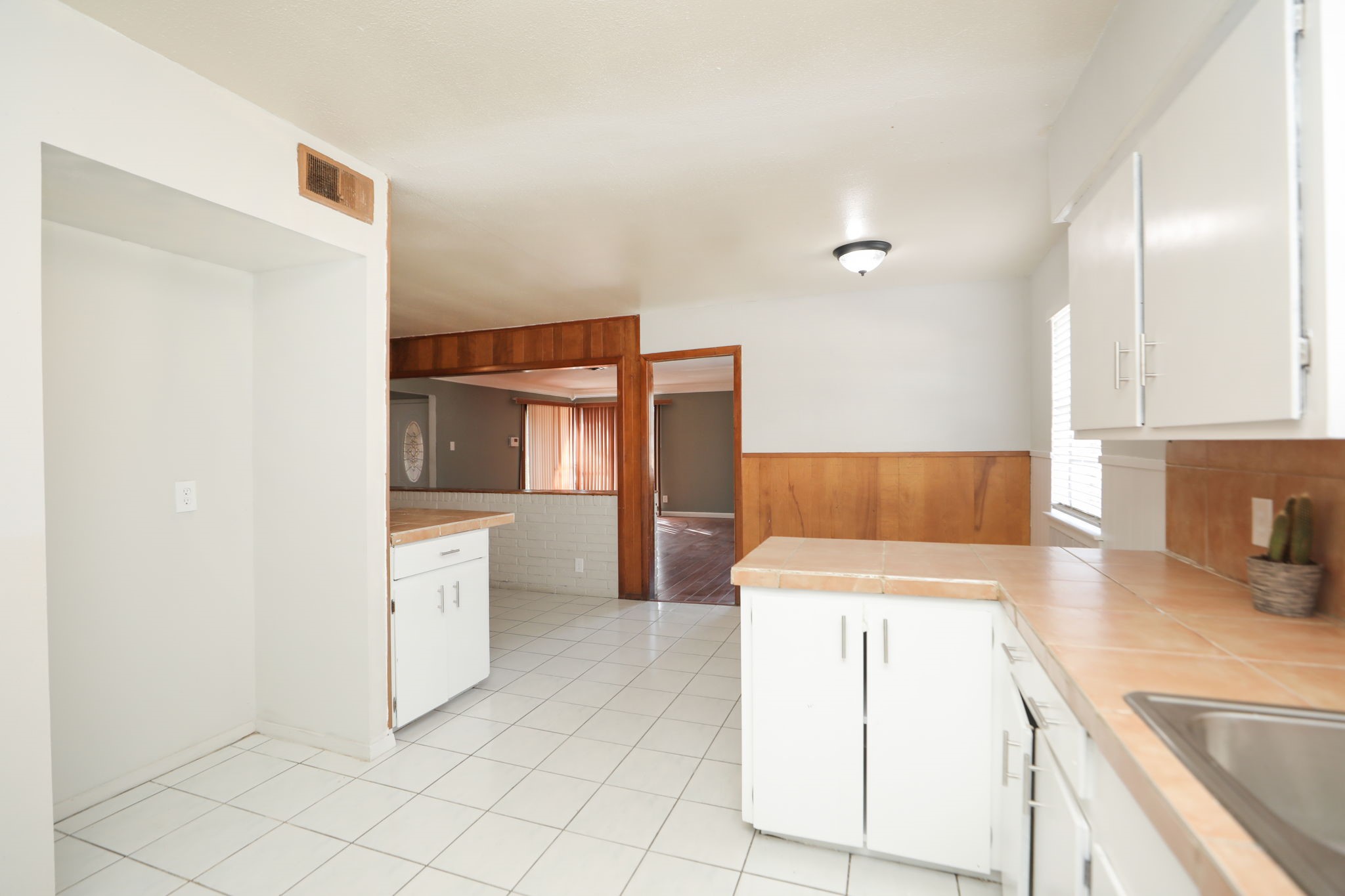 8235 Dover Street Houston, TX 77061 - Photo 17 of 36 a kitchen with granite countertop white cabinets and stainless steel appliances