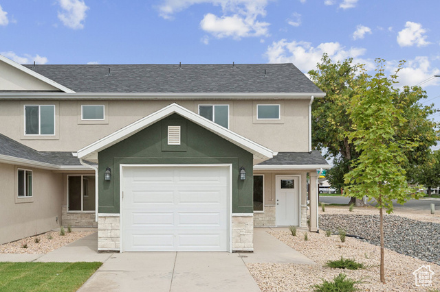1615 North Angel Street, Unit I Layton, UT 84041 - Photo 1 of 56 Traditional-style home with stone siding, stucco siding, a shingled roof, and a garage