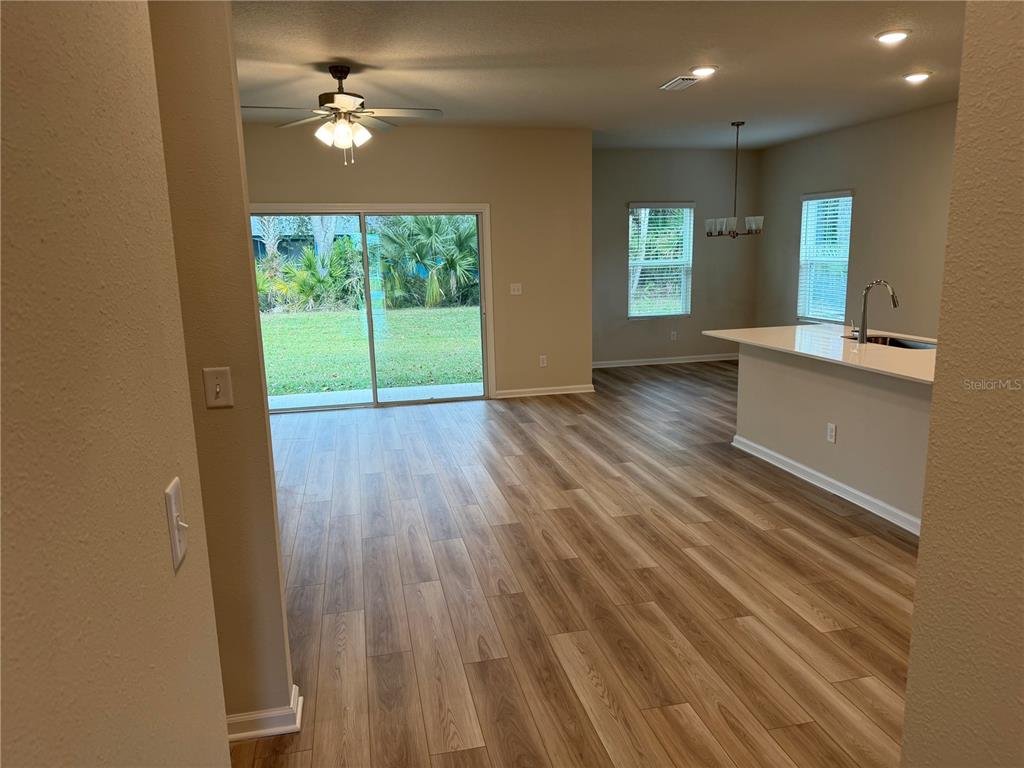 9 Pier Lane Palm Coast, FL 32164 - Photo 7 of 17 wooden floor in an empty room with a window