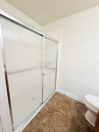 a bathroom with a toilet and a shower