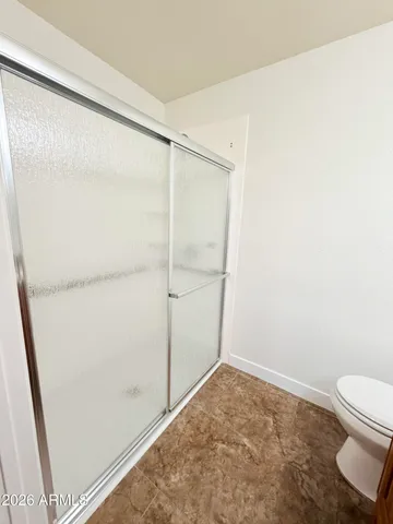 a bathroom with a toilet and a shower