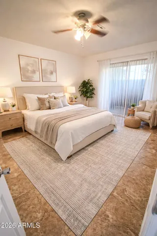 a bedroom with a bed and ceiling fan