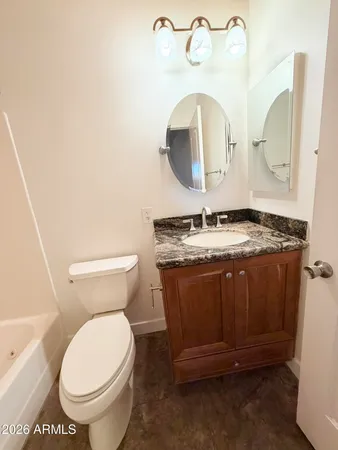 a bathroom with a toilet and a mirror