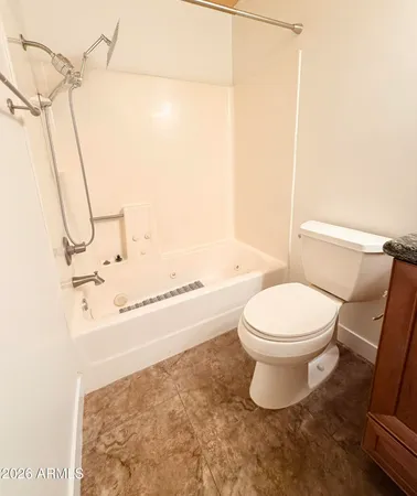 a bathroom with a toilet and a shower
