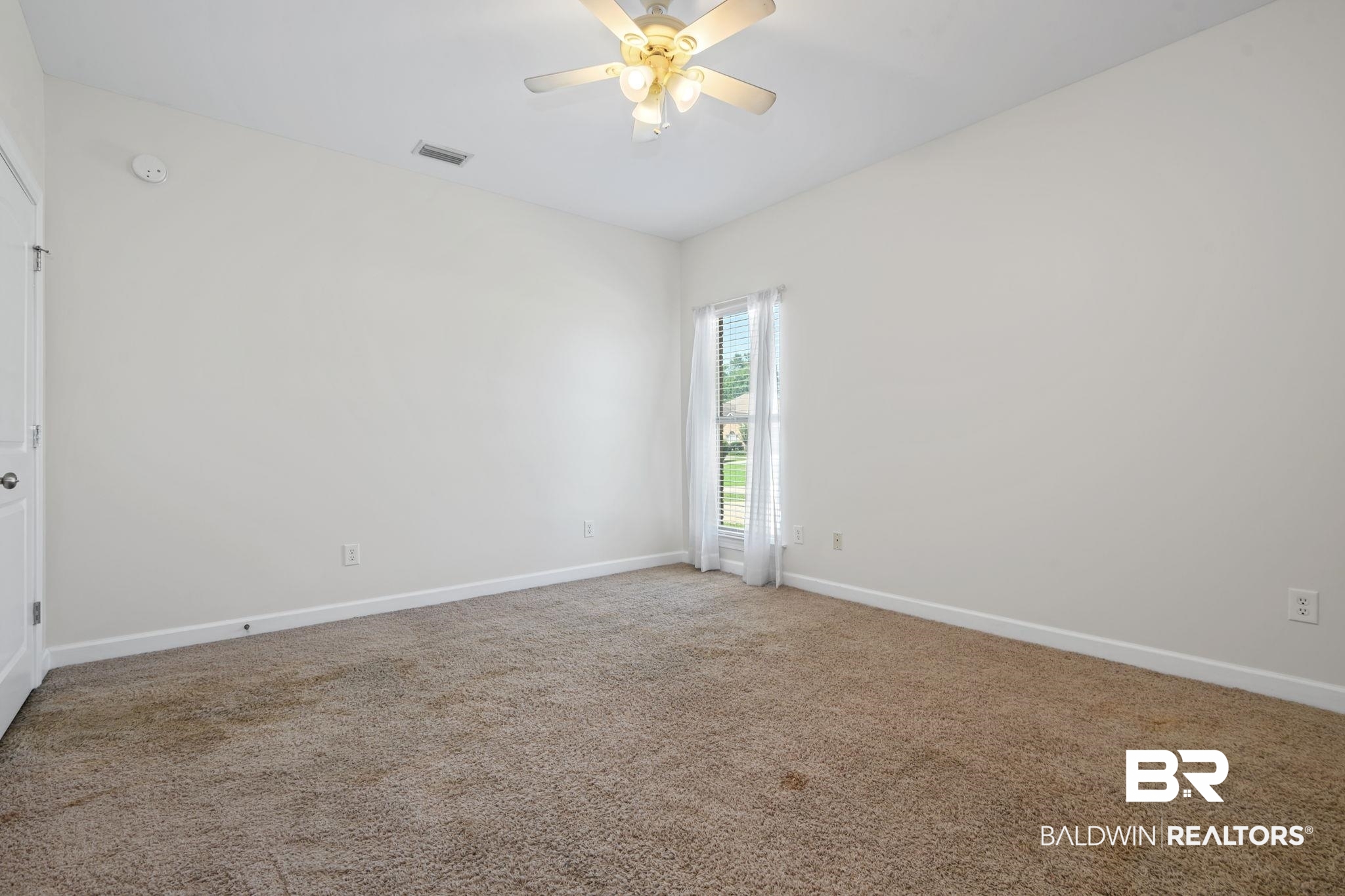 9730 Harmony Ridge Circle West Semmes, AL 36575 - Photo 28 of 38 Spare room featuring carpet flooring, baseboards, ceiling fan, and a smoke detector