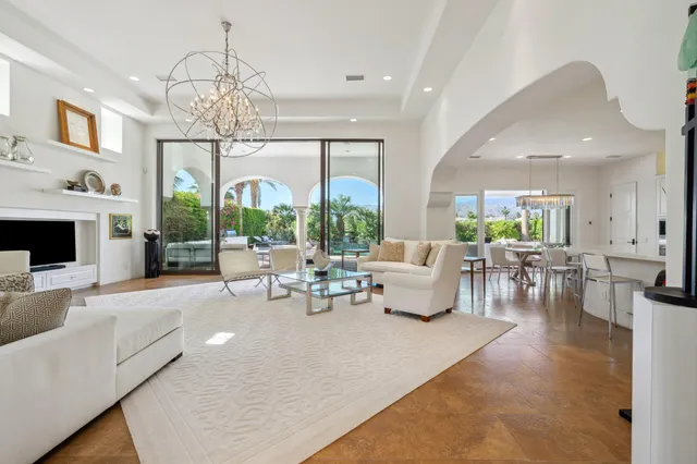 a living room with furniture chandelier and a chandelier