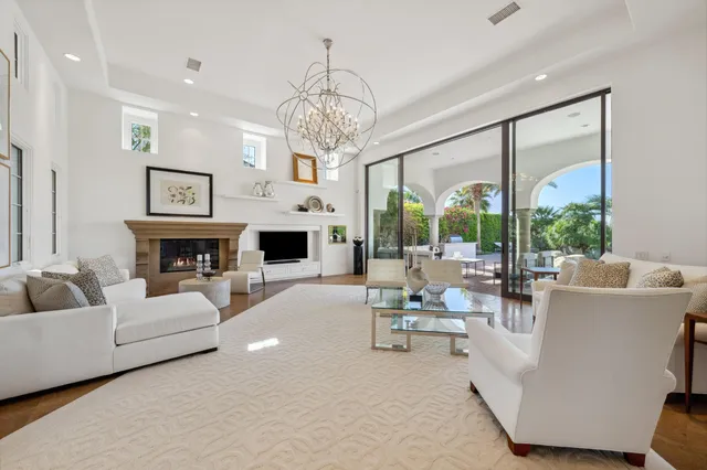 a kitchen with stainless steel appliances kitchen island granite countertop a table chairs stove and white cabinets