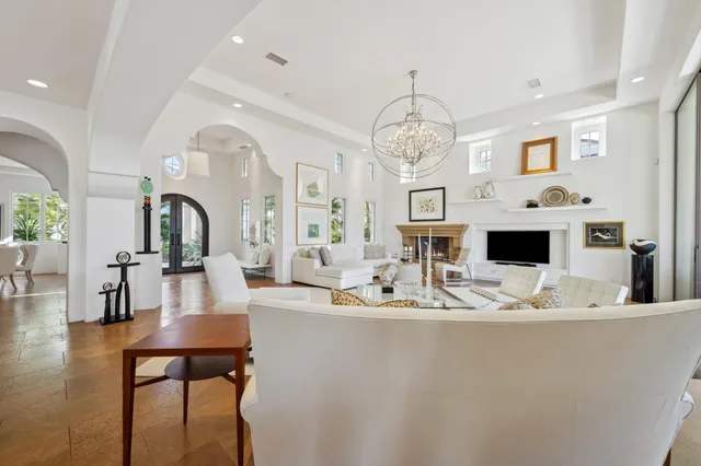 a kitchen with stainless steel appliances kitchen island granite countertop a stove a sink a dining table and chairs