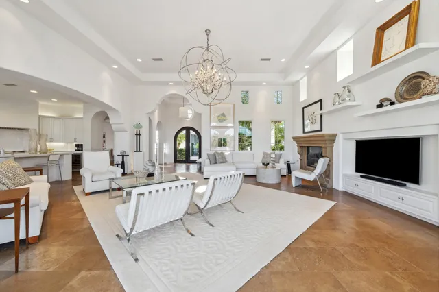 a view of a dining room with furniture a chandelier and wooden floor