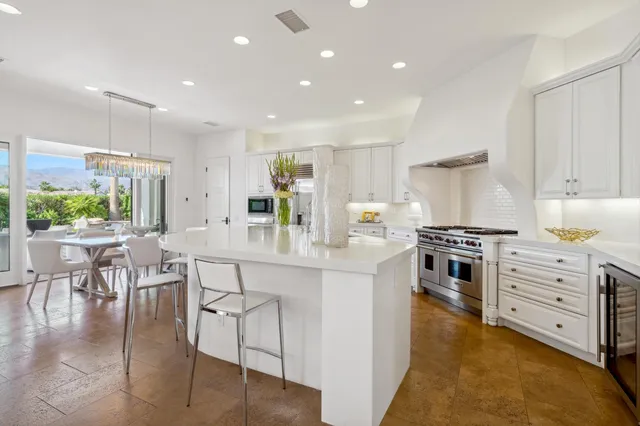 a spacious bedroom with a bed and a flat screen tv