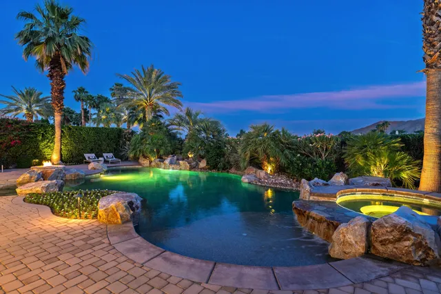 a view of a swimming pool with a table and chairs