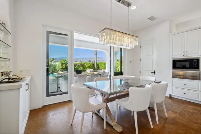 a living room with furniture a flat screen tv and a window